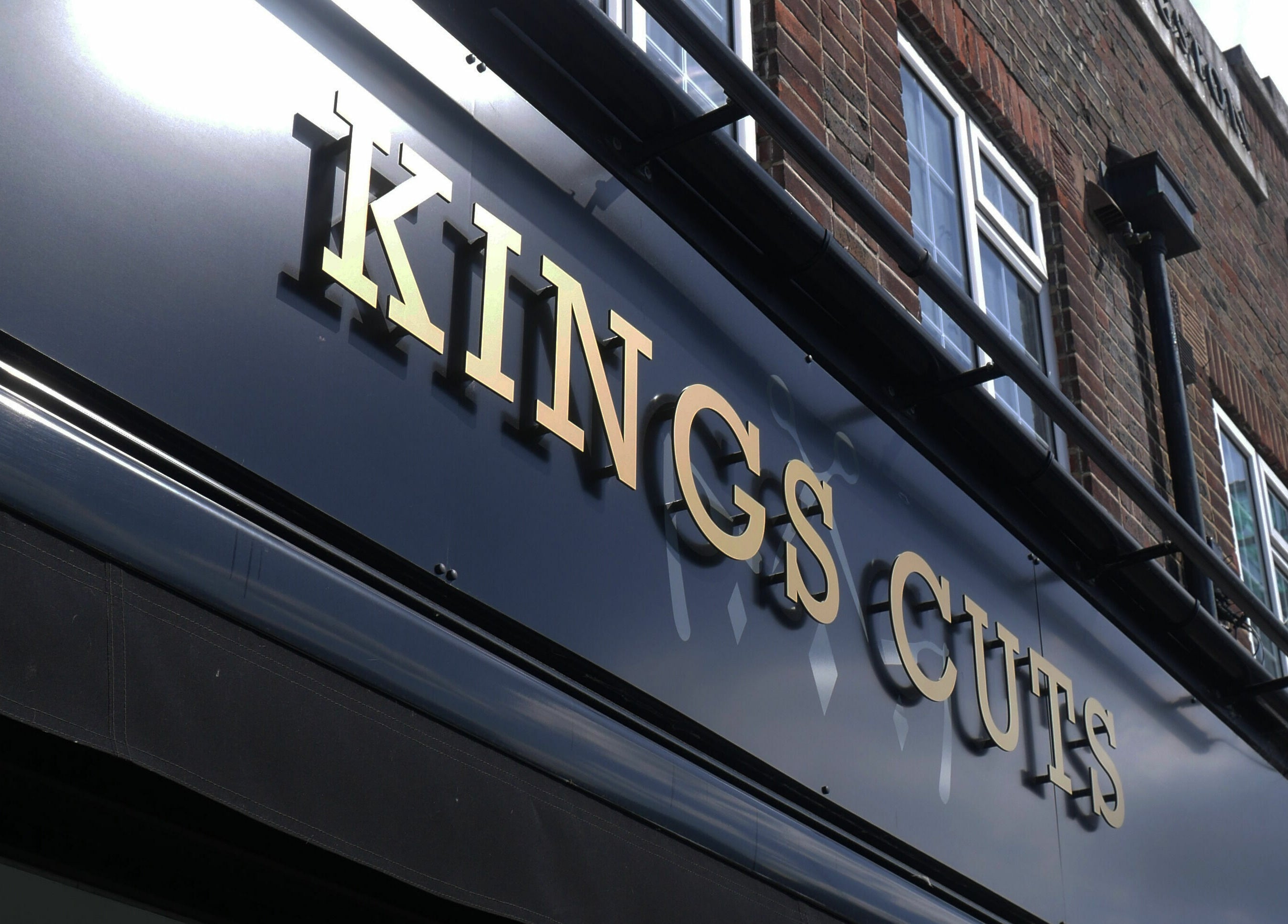 Exterior facade of Kings Cuts with golden letters in Epsom, England, GB.