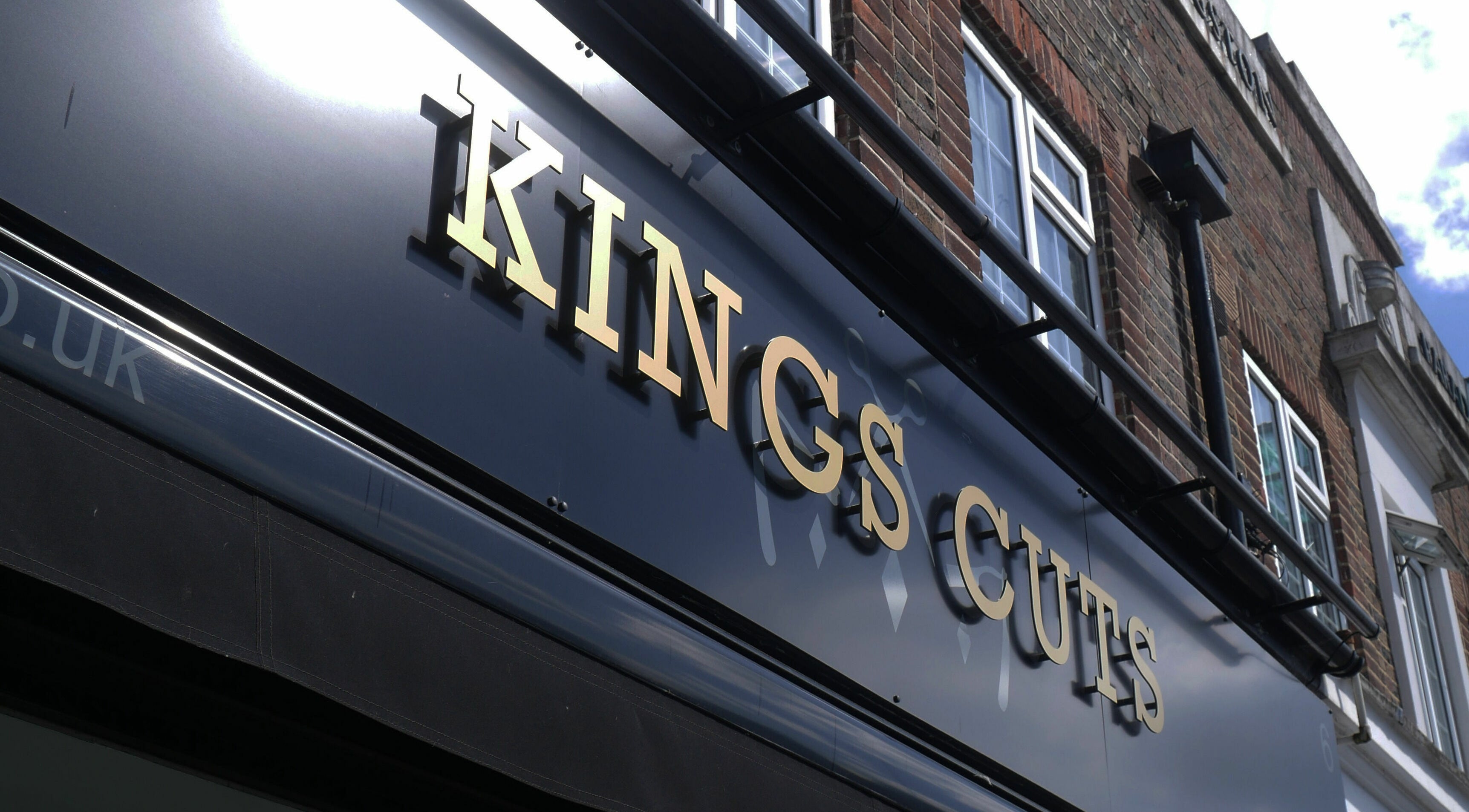 Exterior facade of Kings Cuts with golden letters in Epsom, England, GB.