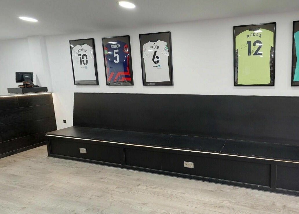 Modern waiting area at Kings Cuts with framed jerseys, located in Epsom, England, GB.