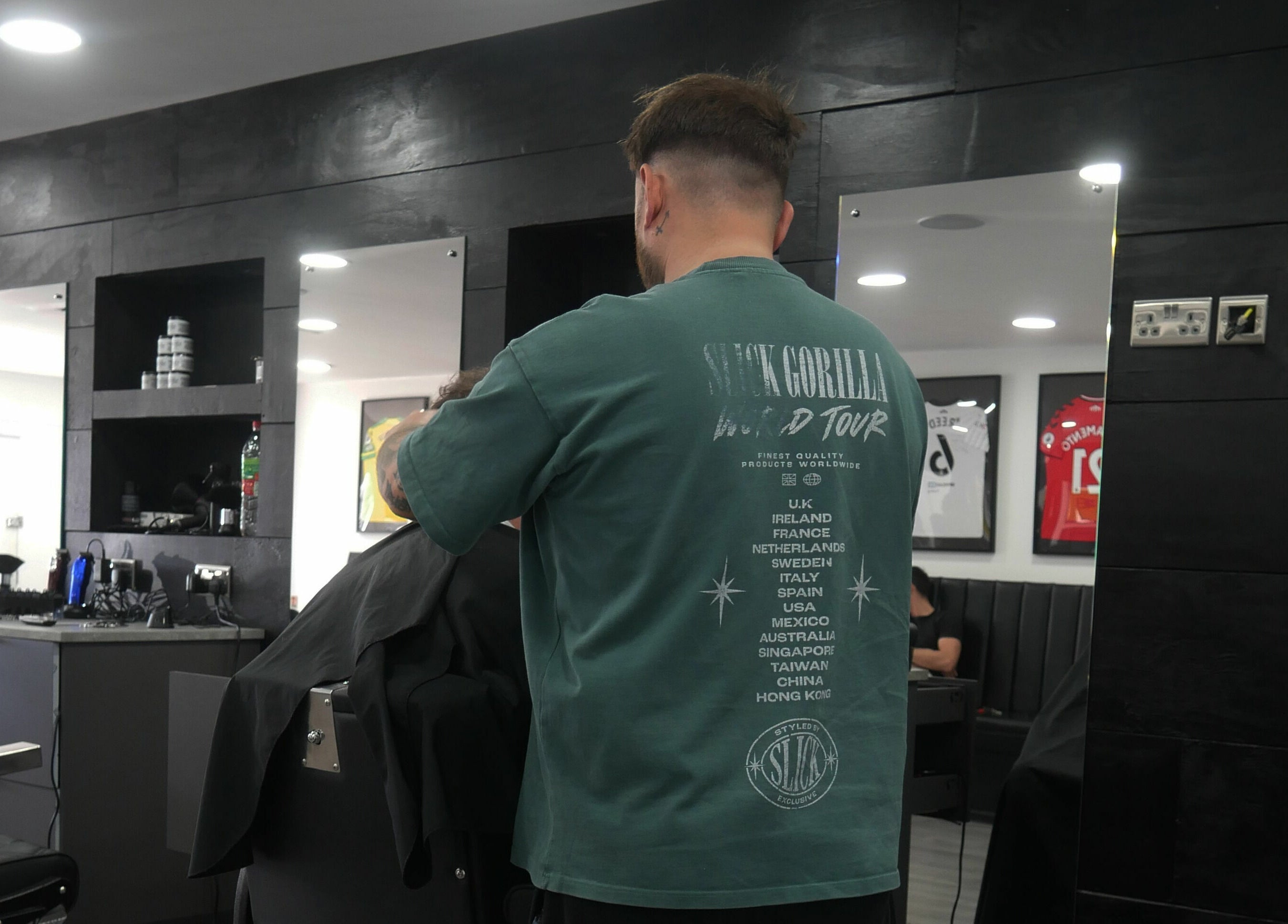 Barber styling hair at Kings Cuts in Epsom, England, GB, showcasing modern interior and design.