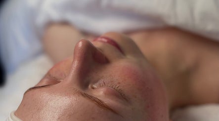 Relaxed face during spa treatment at Noney Skin, Glasgow, Scotland, GB, showcasing a glowing complexion.