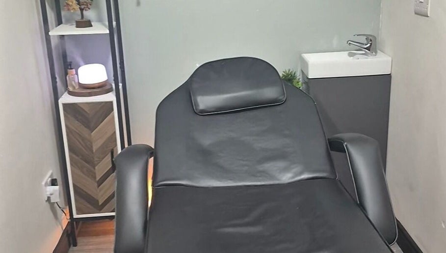 Calming therapy room at Holistic Healing Hands, Lurgan, Northern Ireland, GB with a black recliner and soft lighting.