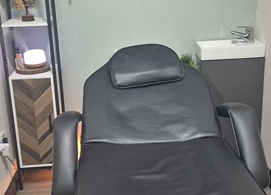Calming therapy room at Holistic Healing Hands, Lurgan, Northern Ireland, GB with a black recliner and soft lighting.