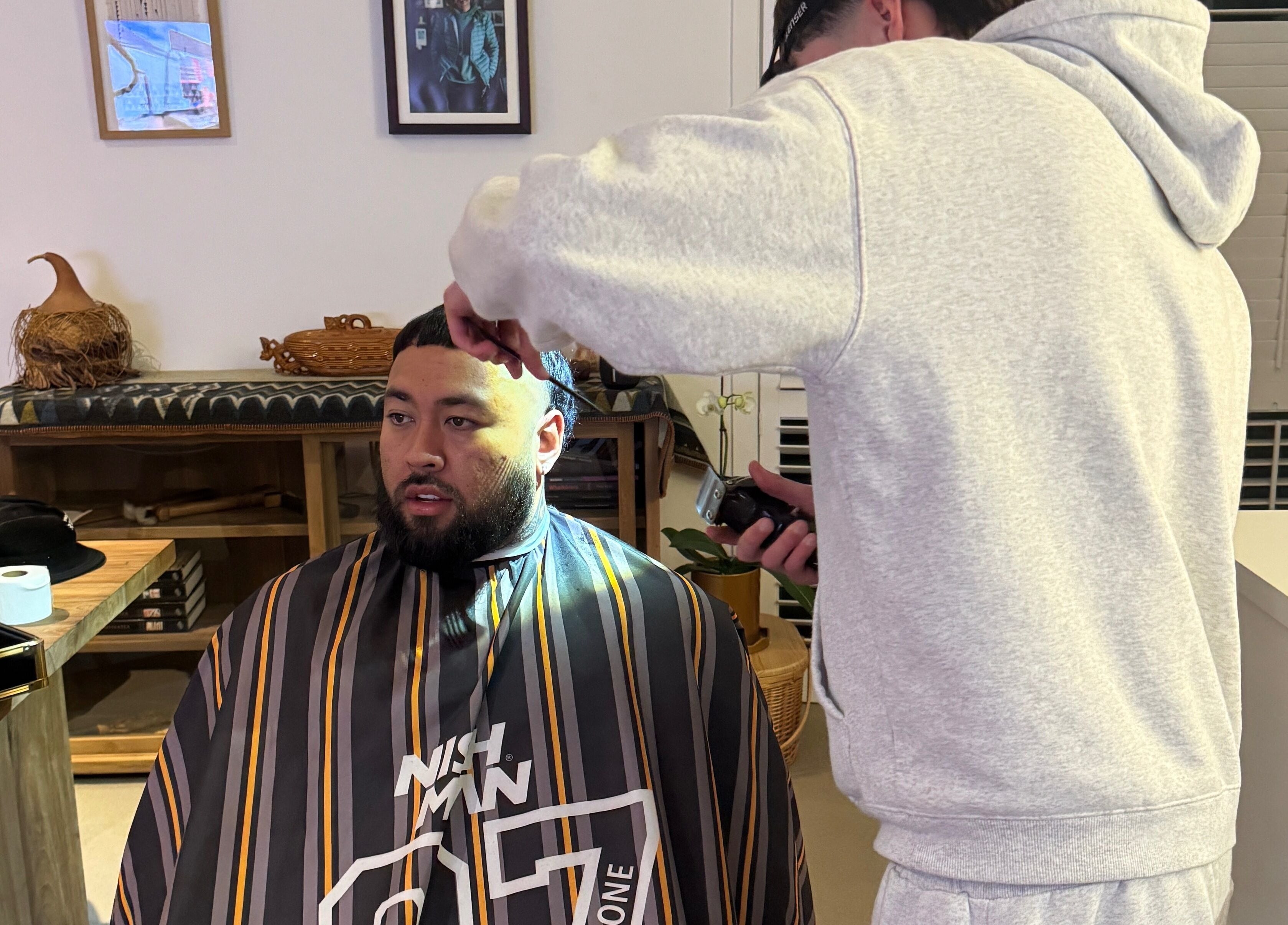 Barber styling a man's hair at FADEZ BY KYE, located in Tauranga, Mount Maunganui, NZ.