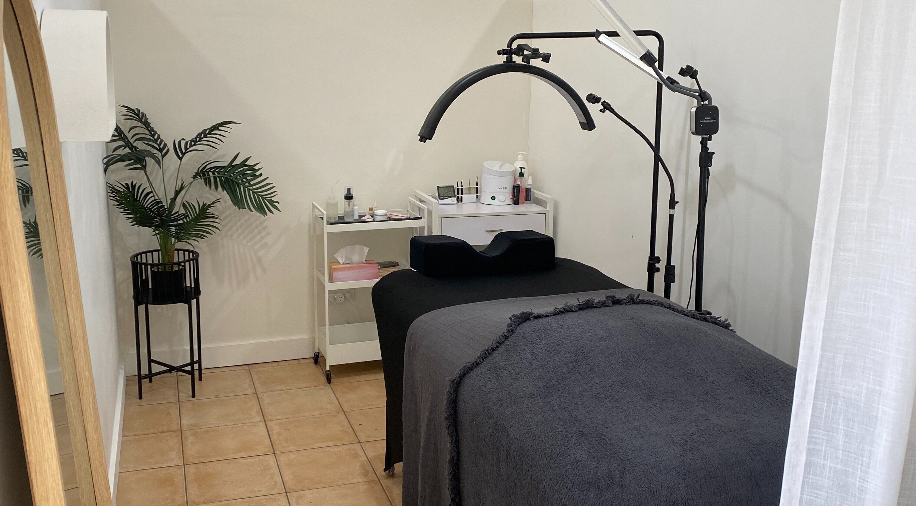 Tranquil treatment room at Kelaya Beauty, North Brighton, SA, AU with therapy bed and modern decor.