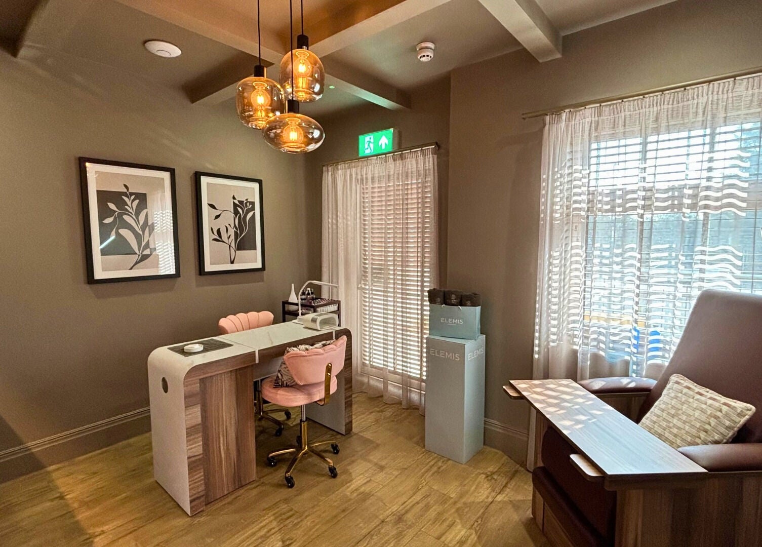Cozy nail station at The Hillbrook, Sherborne, England, GB, featuring chic chairs and warm lighting.