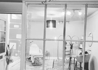 Front view of Bespoke Body Sculpting's elegant interior in Bath, England, GB, featuring modern decor and a plush chair.