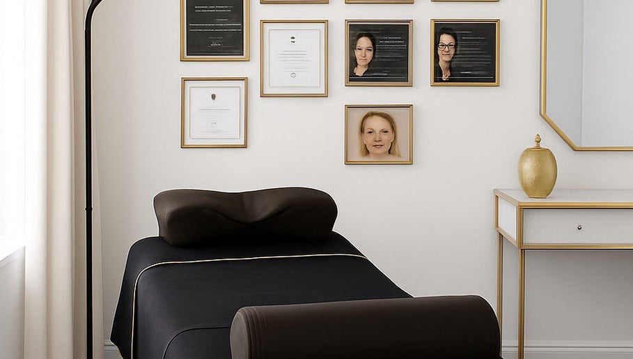 Modern treatment room at Lash Eyelashes, Southampton, England, GB with a sleek black bed and gold decor.