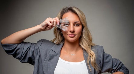 Woman displays eyelash brushes at Lash Eyelashes, Southampton, England, GB for beauty enhancement.