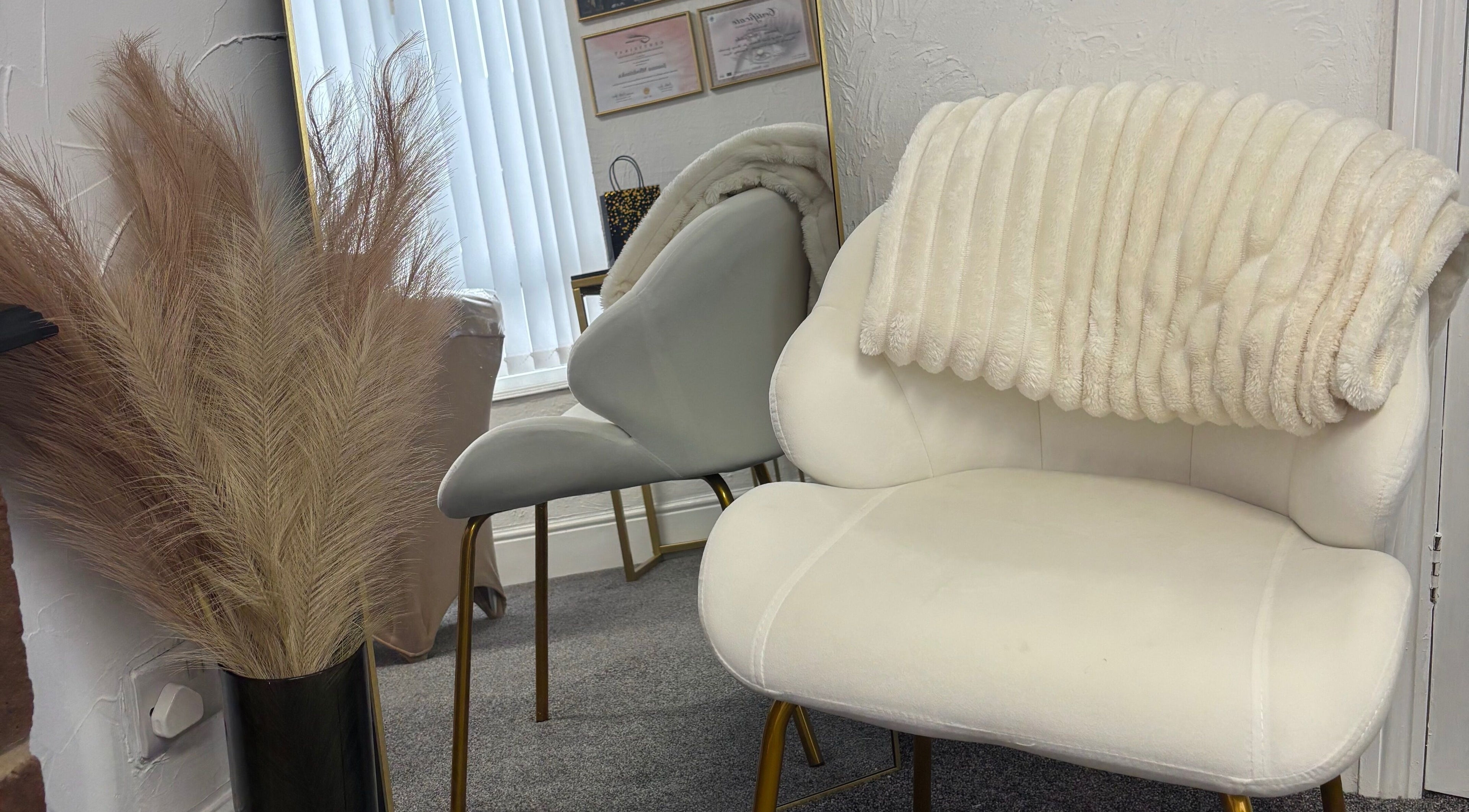 Comfortable lounge chairs with plush throw at Lash Eyelashes, Southampton, England, GB.