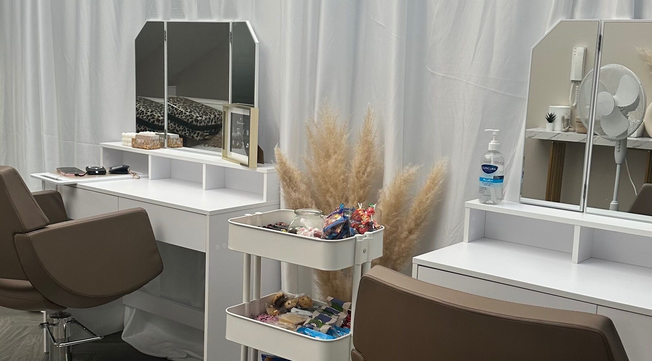 Elegant beauty station at HairByElizabeth, London, England, GB features a mirror, chair, and fresh decor.