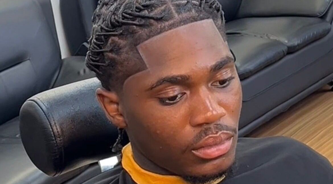 Client with detailed haircut at Island Barbershop, Enfield, England, GB. Showcases expert styling services.