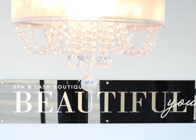 Chic chandelier above 'Beautiful You Spa & Lash Boutique' sign in Tillsonburg, Ontario, CA.
