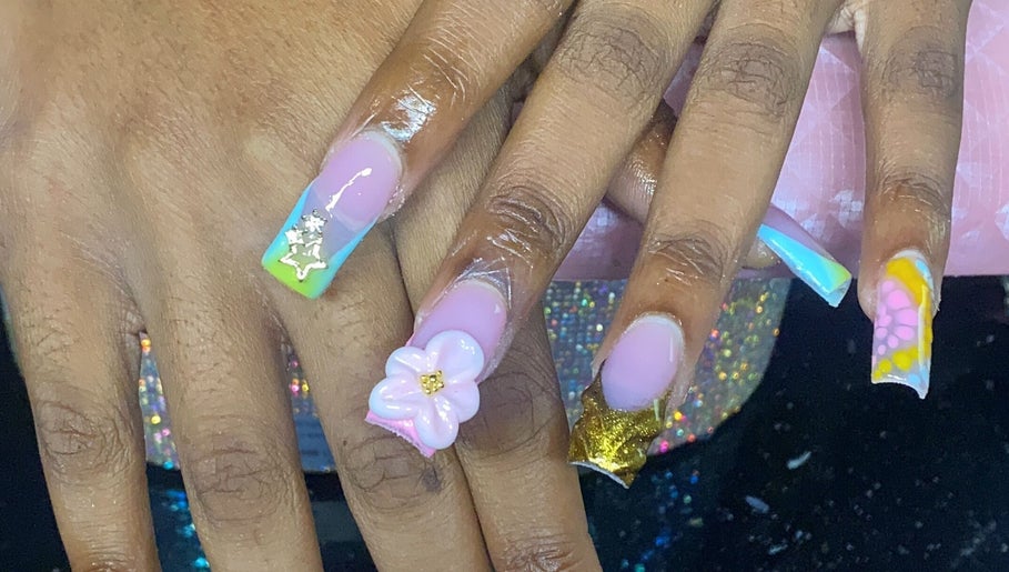 Vibrant floral nail art at Naileditby_des, Paulsboro, New Jersey, US. Creative pastel and gold design.