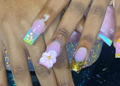 Vibrant floral nail art at Naileditby_des, Paulsboro, New Jersey, US. Creative pastel and gold design.