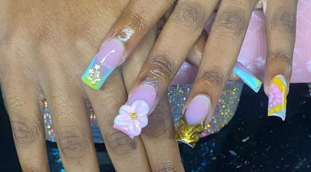 Vibrant floral nail art at Naileditby_des, Paulsboro, New Jersey, US. Creative pastel and gold design.