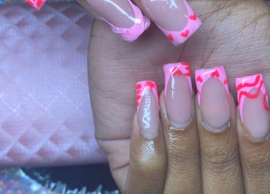 Stylish pink nail art with heart designs by Naileditby_des in Paulsboro, New Jersey, US.
