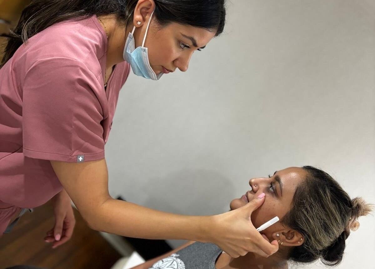 Specialist at DAS Aesthetics in London, England, GB conducts a facial assessment session.