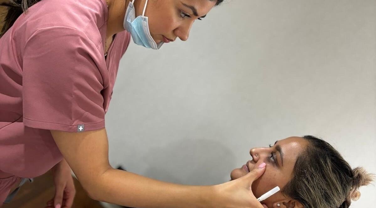 Specialist at DAS Aesthetics in London, England, GB conducts a facial assessment session.