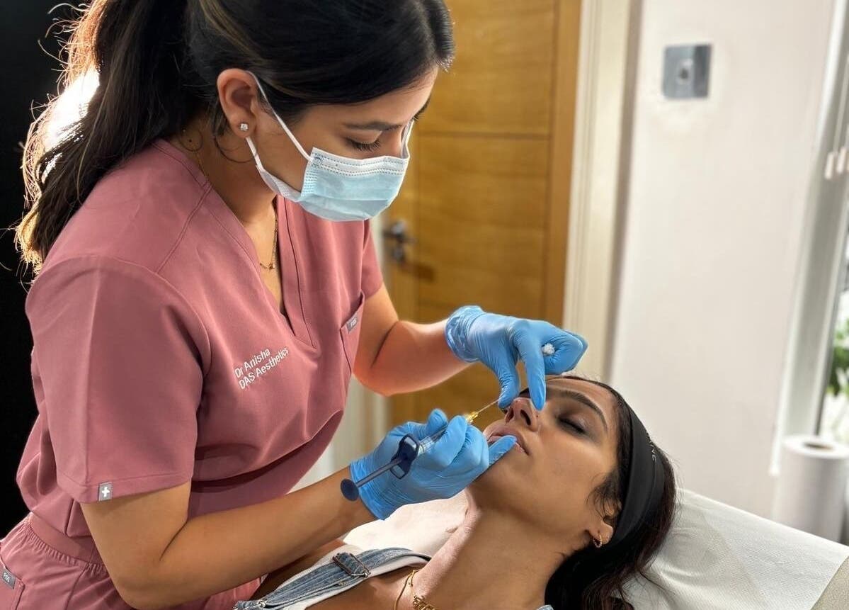 Professional aesthetic practitioner at DAS Aesthetics, London, England, GB performing a cosmetic procedure.