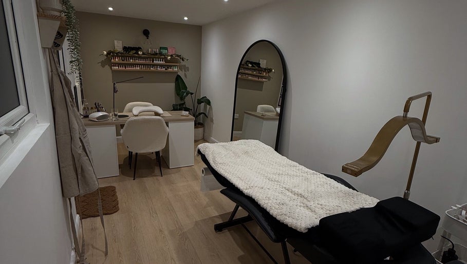 Cozy treatment room at Hollie Louise Beauty in Tavistock, England, GB featuring a plush bed and elegant decor.