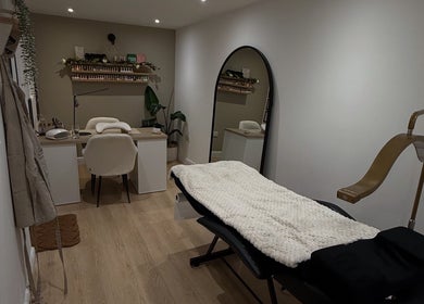 Cozy treatment room at Hollie Louise Beauty in Tavistock, England, GB featuring a plush bed and elegant decor.