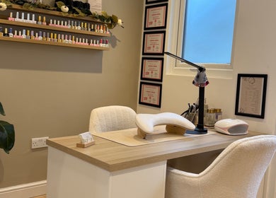 Elegant nail station at Hollie Louise Beauty in Tavistock, England, GB, showcasing manicure tools and cozy seating.