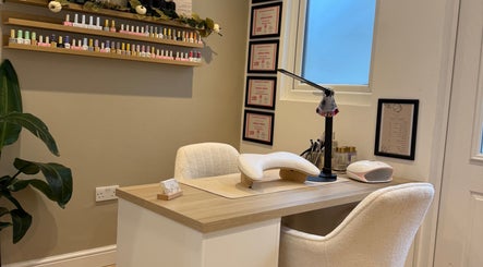 Elegant nail station at Hollie Louise Beauty in Tavistock, England, GB, showcasing manicure tools and cozy seating.