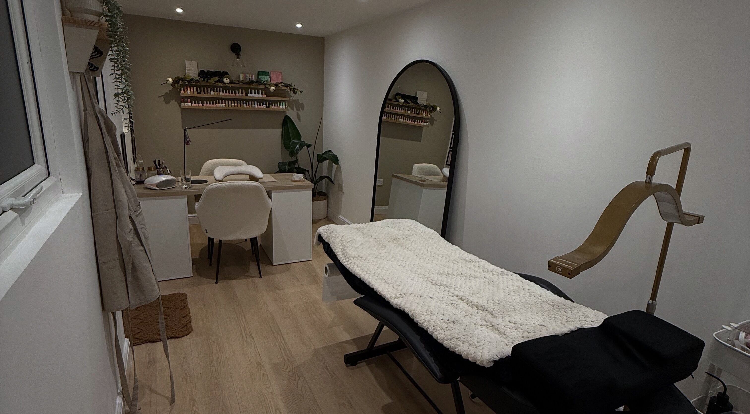 Tranquil treatment room at Hollie Louise Beauty, Tavistock, England, GB with cozy furnishings and modern design.