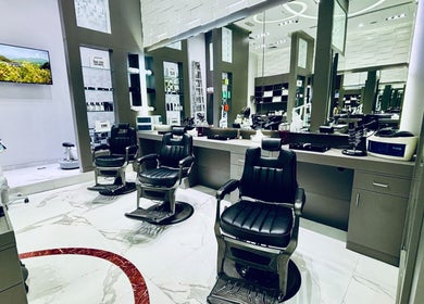 Modern barber chairs at Big City Barbershop, Dubai, AE, showcasing sleek design and elegance.