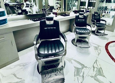 Sleek black barber chairs at Big City Barbershop, Dubai, Dubai, AE, offering luxurious grooming services.