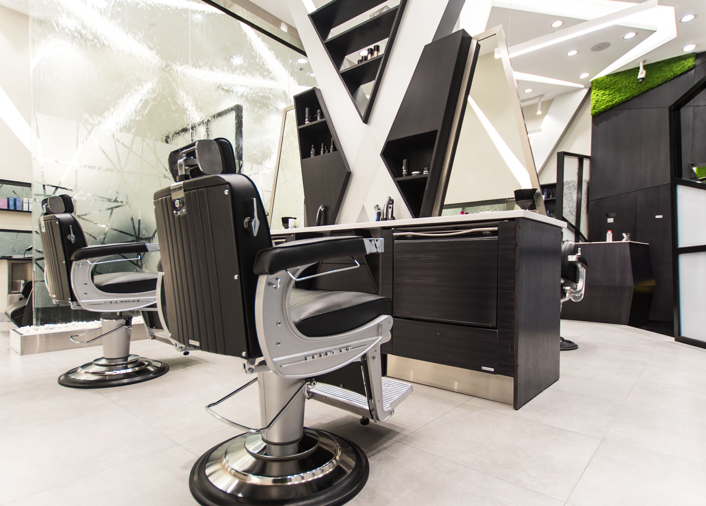 Chic barber chairs at X Hair Lounge - City Center Mirdif, Dubai, AE for upscale grooming services.