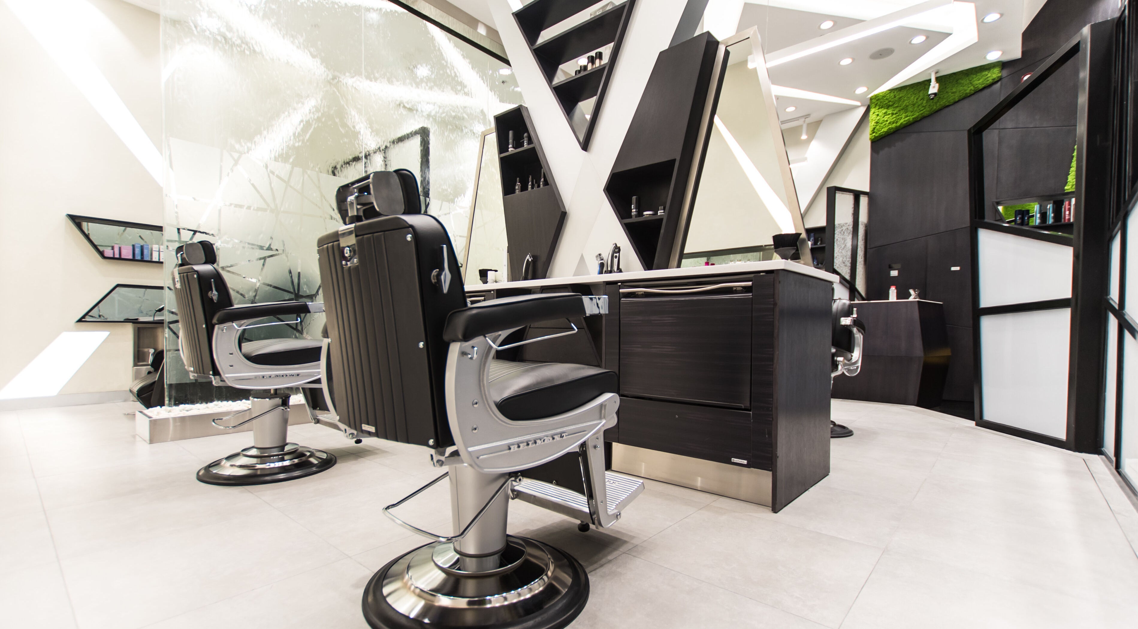 Chic barber chairs at X Hair Lounge - City Center Mirdif, Dubai, AE for upscale grooming services.