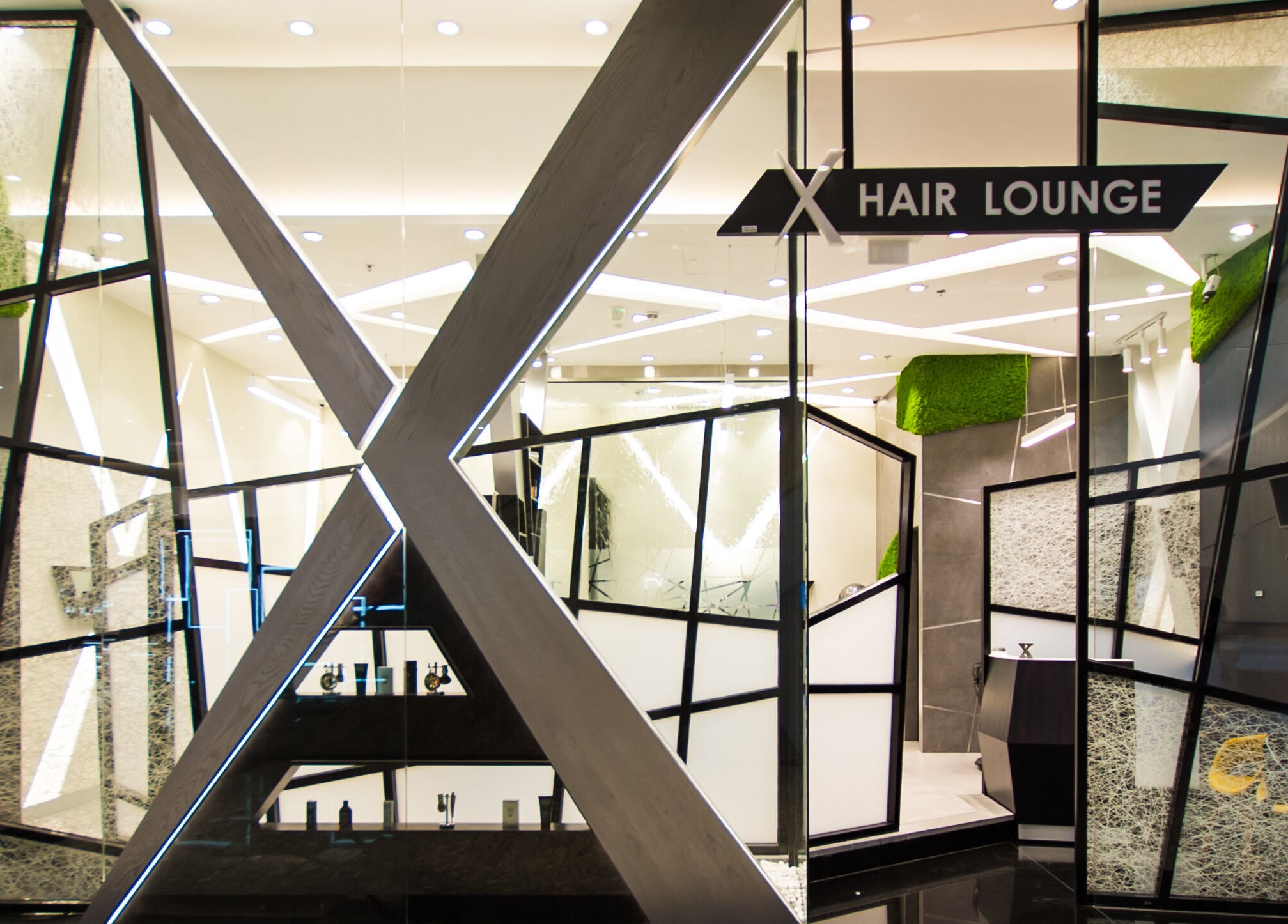 Chic entrance of X Hair Lounge - City Center Mirdif, Dubai, AE with modern geometric design.