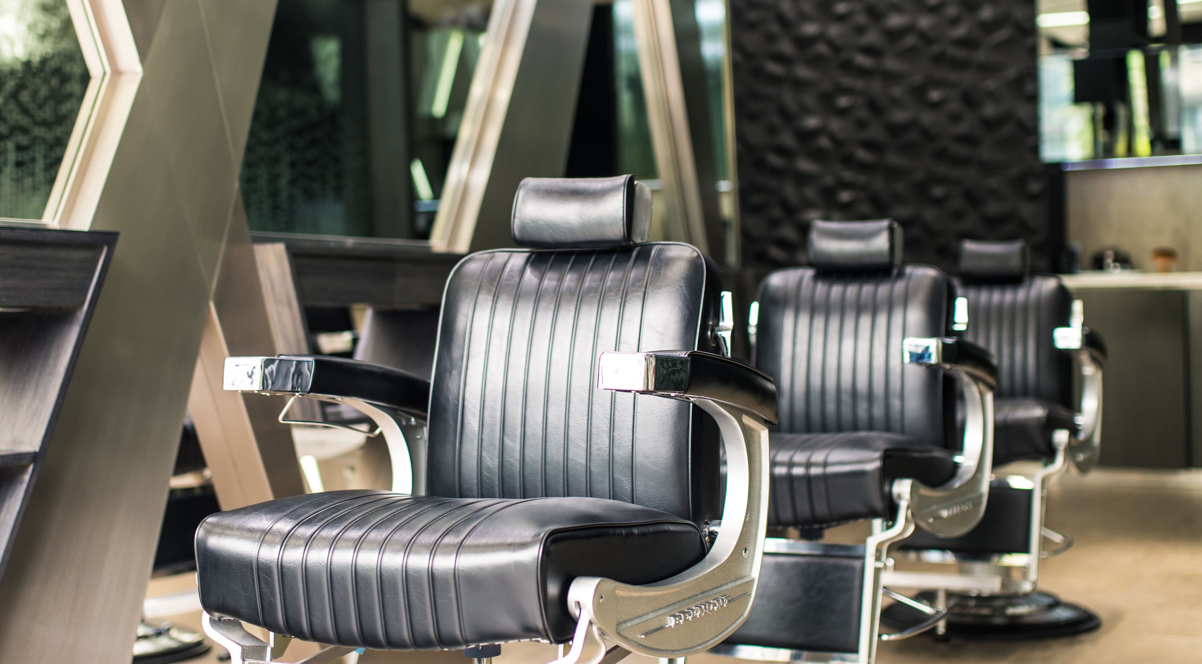 Luxurious salon chairs at X Hair Lounge - City Walk, Dubai, AE, highlighting upscale styling experience.