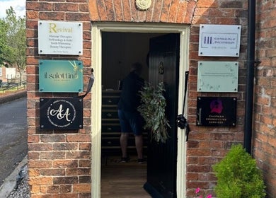 Entrance of Wax and Go, Bawtry Doncaster, England, GB with visible signage on a brick wall.