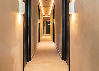 Calming hallway at Aura Head Spa, Ridgewood, New Jersey, US, illuminated with warm lights for a relaxing ambiance.