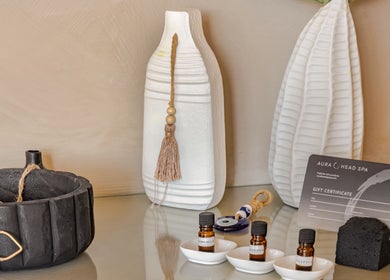 Decorative display with essential oils and a gift certificate at Aura Head Spa | Ridgewood, New Jersey, US.