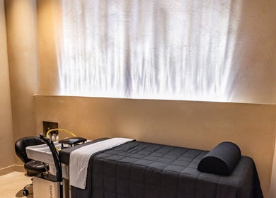 Relaxation room at Aura Head Spa | Ridgewood, New Jersey, US, featuring a massage bed and ambient lighting.