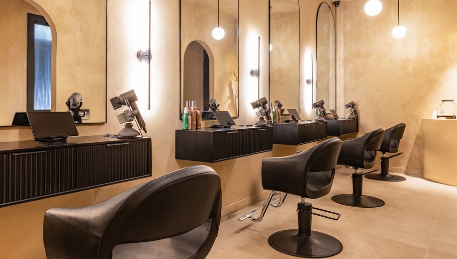 Modern beauty salon interior at Aura Head Spa | Ridgewood, Ridgewood, New Jersey, US with stylish black chairs and mirrors.