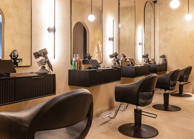 Modern beauty salon interior at Aura Head Spa | Ridgewood, Ridgewood, New Jersey, US with stylish black chairs and mirrors.
