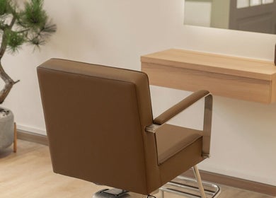 Elegant salon chair and mirror at Jo:Hwa Hair & Living, Singapore, Singapore, SG, offering a serene atmosphere.