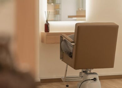 Modern salon chair at Jo:Hwa Hair & Living, Singapore, creating a stylish ambiance in a well-lit space.