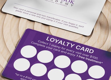 DivaLook Academy Inc. loyalty card offering rewards in Montréal, Québec, CA. Cards on wooden background.