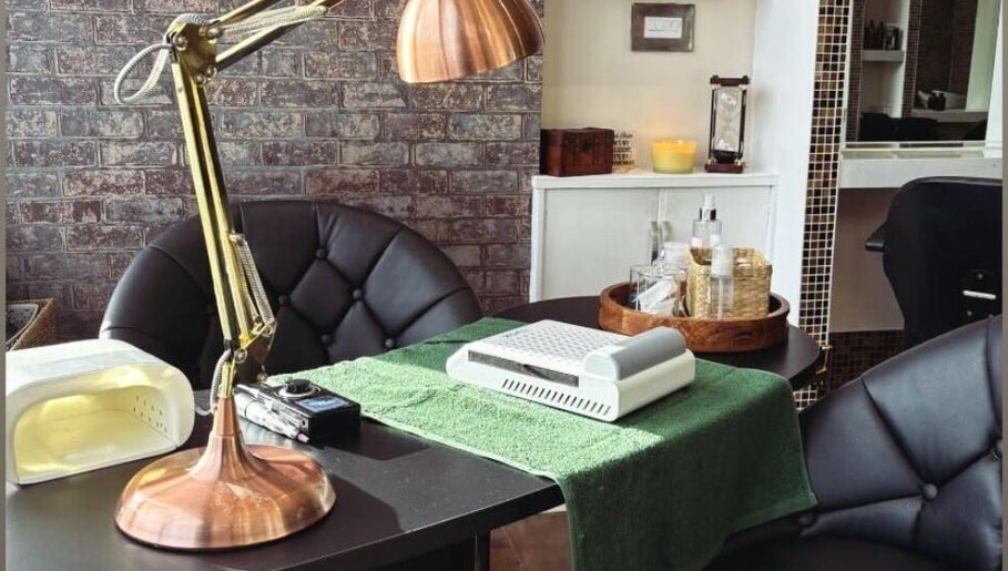 Elegant nail care setup at The Hair Duo, Airdrie, Scotland, GB, featuring a stylish lamp and neatly organized tools.