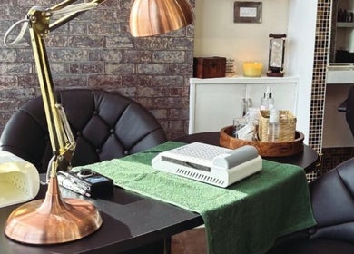 Elegant nail care setup at The Hair Duo, Airdrie, Scotland, GB, featuring a stylish lamp and neatly organized tools.