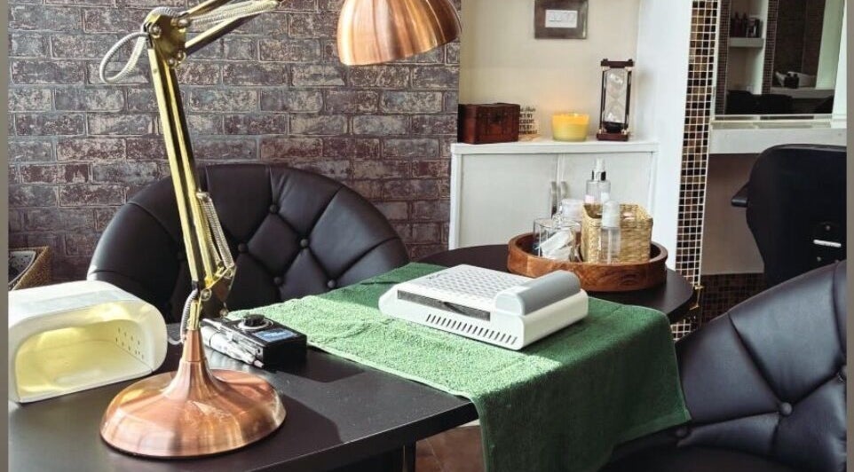 Elegant nail care setup at The Hair Duo, Airdrie, Scotland, GB, featuring a stylish lamp and neatly organized tools.