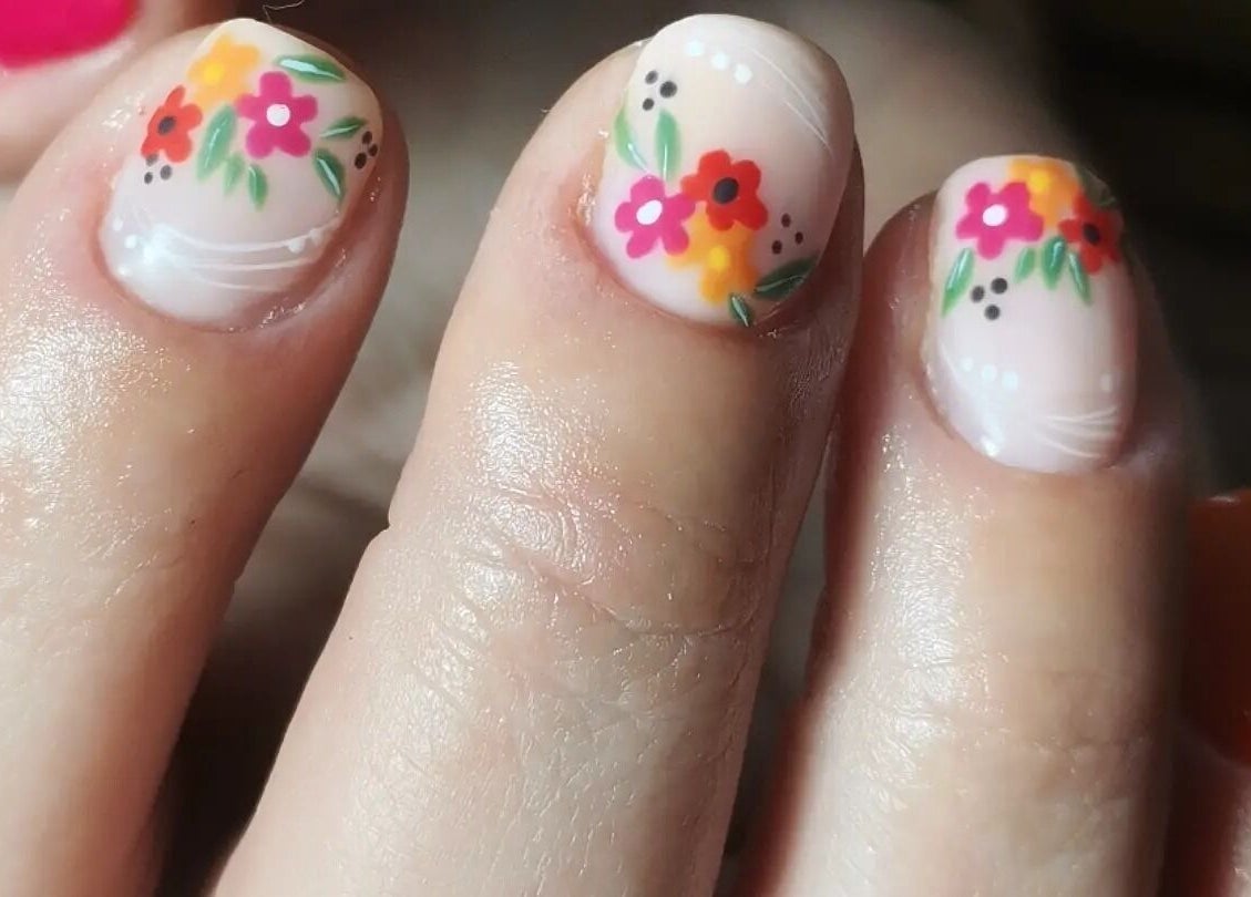 Floral nail art design at Raak Rustig Nails, Jeffreys Bay, Eastern Cape, ZA. Bright flowers on a nude base.