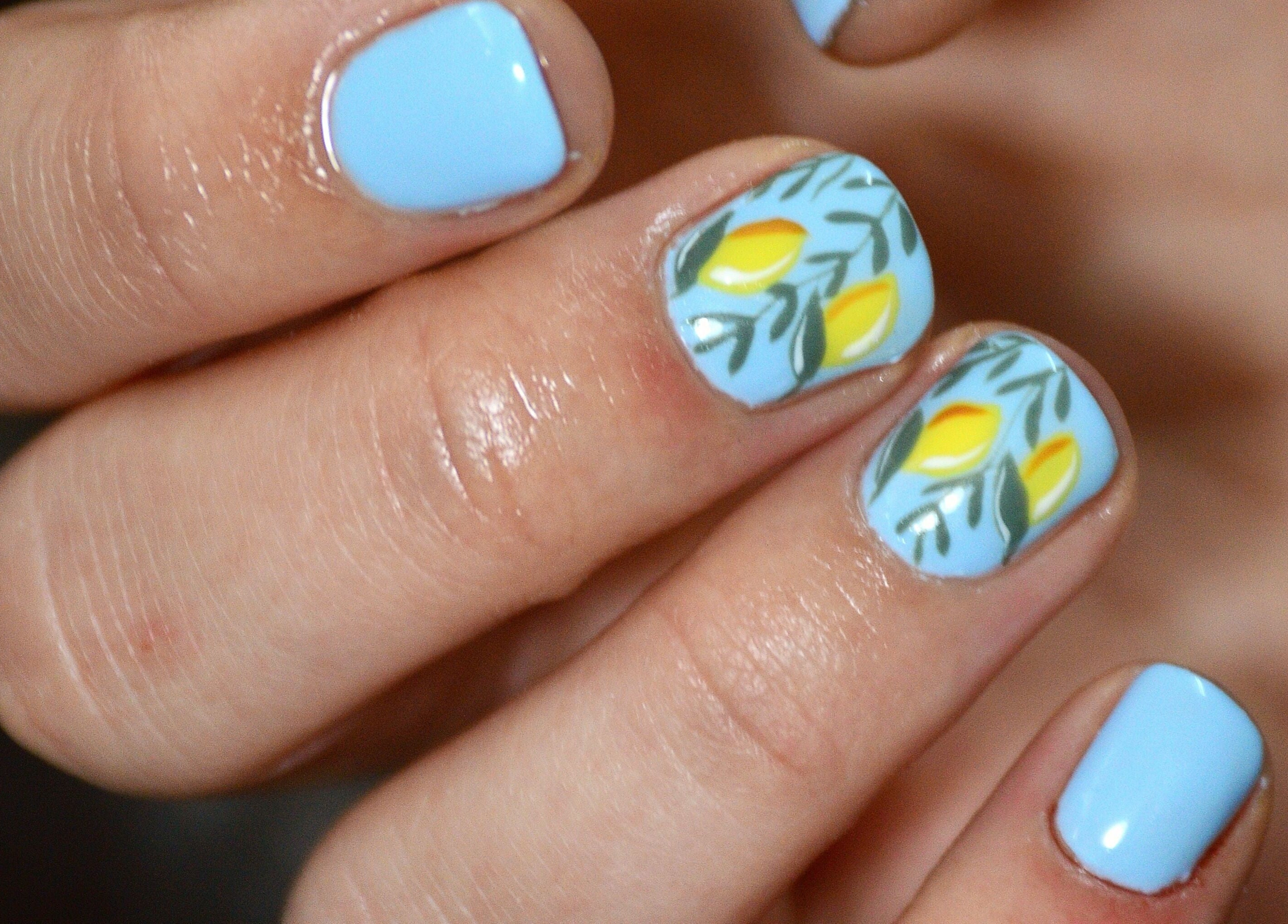 Blue nails with yellow floral design at Raak Rustig Nails, Jeffreys Bay, Eastern Cape, ZA.