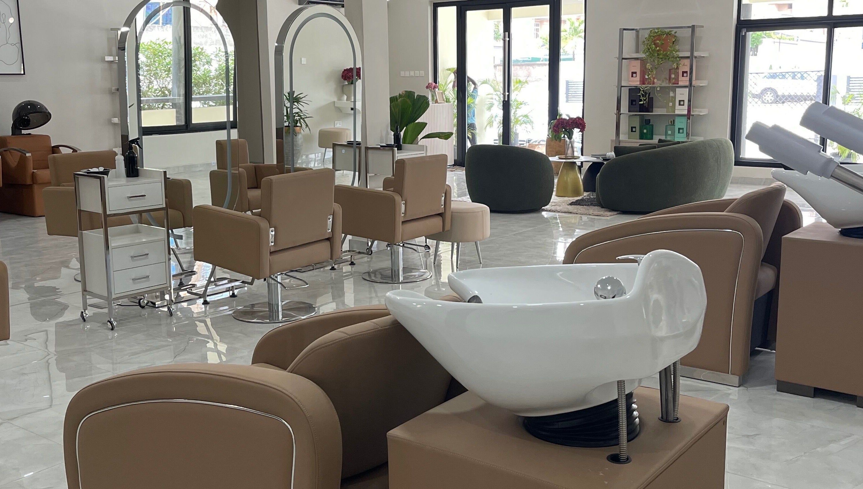 Spacious, modern interior of Kai Beauty Studio in Accra, Greater Accra Region, GH, with stylish seating and mirrors.